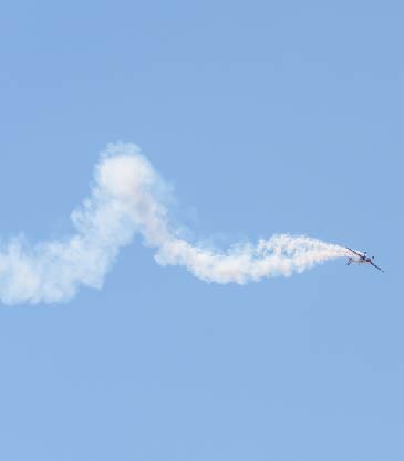 Plane doing aeroobatics with smoke following